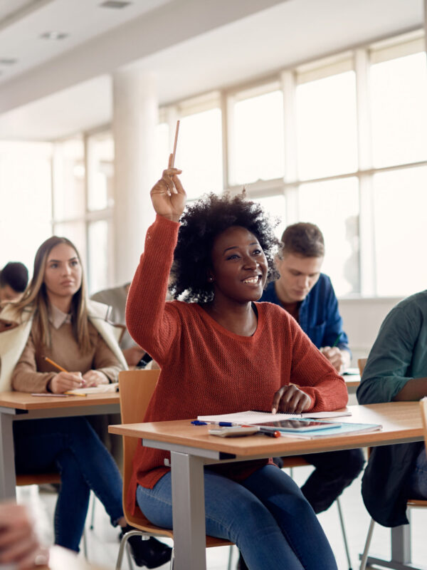 Student-raising-hand-in-classroom-Adobe-Stock-scaled.jpeg