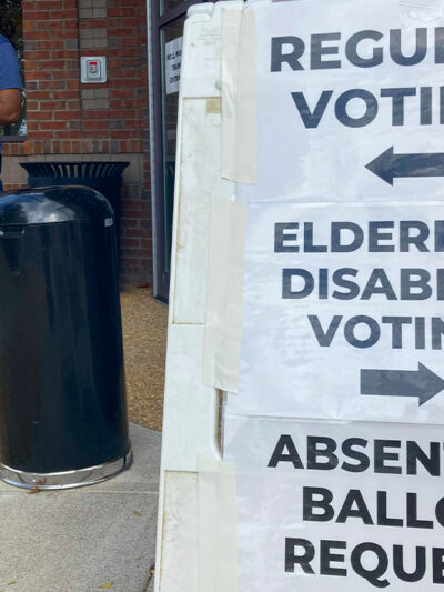 A sandwich board with directions posted on signs showing the way to vote outside a Cobb County voting building in Marietta, Ga.