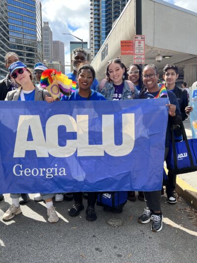 people in parade holding ACLU of Georgia banner