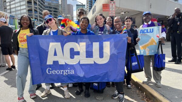 people in parade holding ACLU of Georgia banner
