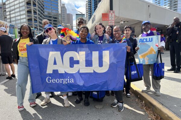 people in parade holding ACLU of Georgia banner