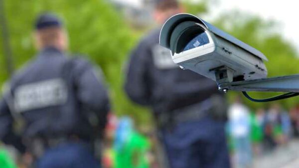 security camera with officers blurred in the background