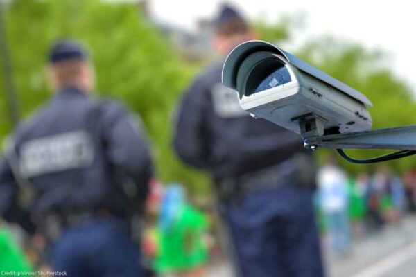 security camera with officers blurred in the background