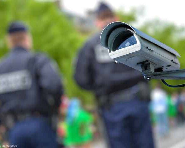 security camera with officers blurred in the background