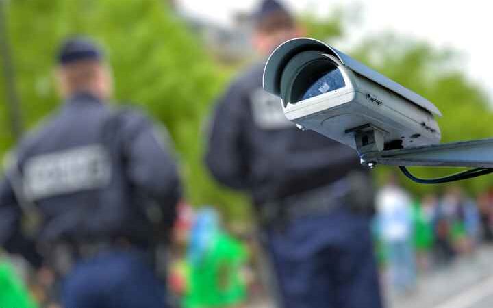 security camera with officers blurred in the background
