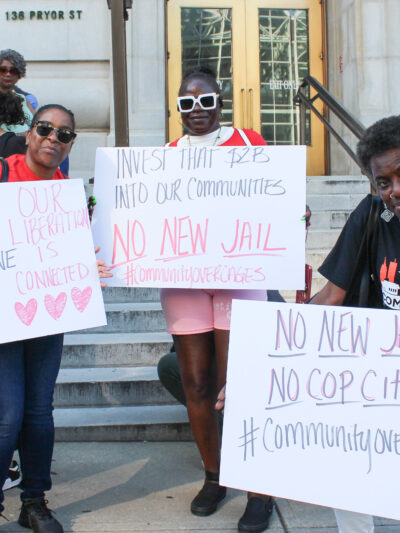 Community Over Cages press conference 2024 Signage