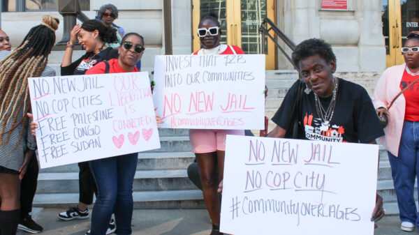 Community Over Cages press conference 2024 Signage