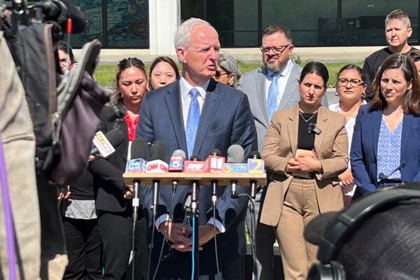 Lawyers addressing media about student visa revocations outside a federal court building in Atlanta