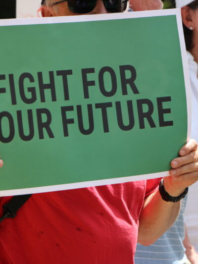person holding sign that says fight for our future