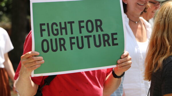 person holding sign that says fight for our future