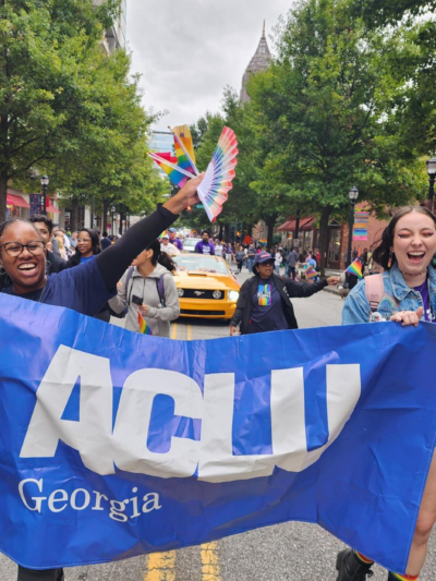 People with ACLU of Georgia banner marching in Pride parade