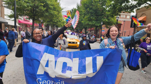 People with ACLU of Georgia banner marching in Pride parade