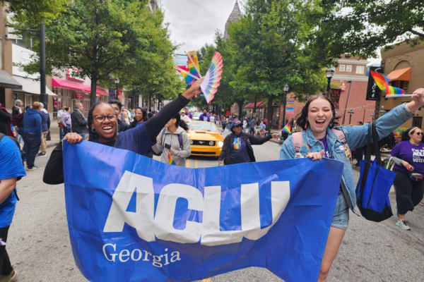 People with ACLU of Georgia banner marching in Pride parade