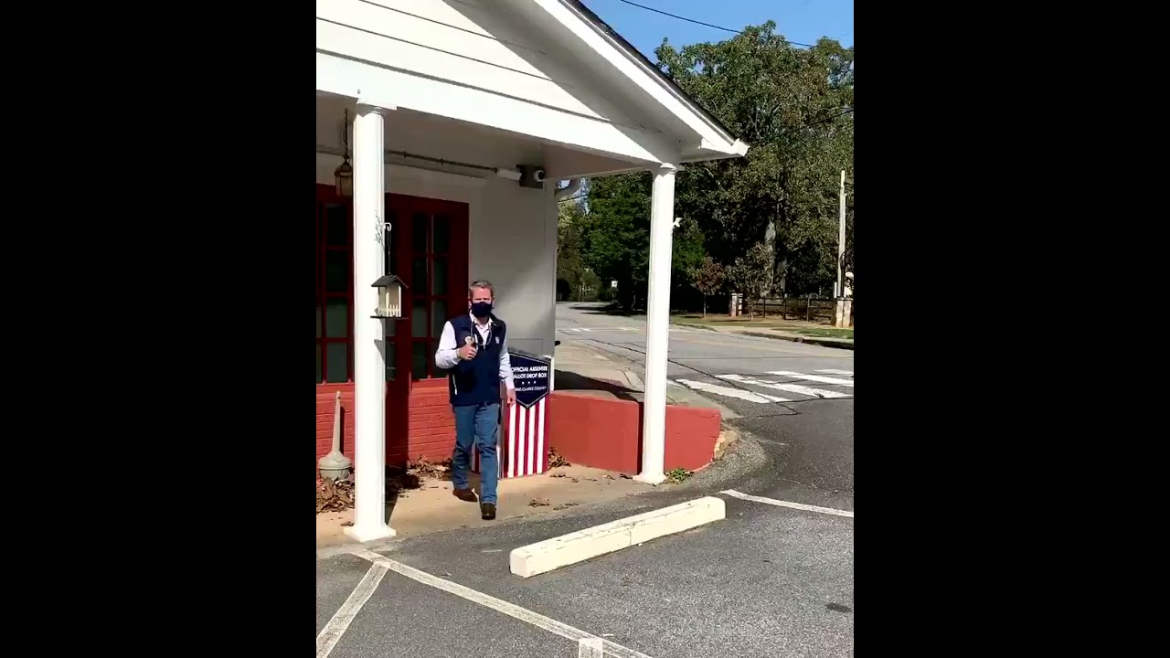 Kemp returning absentee ballot to dropbox on Election Day