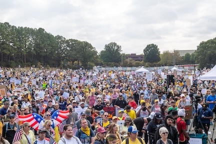 An estimated crowd of 12,000 people filled the parking lot of the Atlanta Civic Center for the October 18, 2025 No Kings Rally at the Atlanta Civic Center.