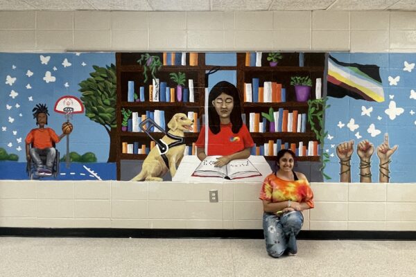 Deepali Patel with disability awareness mural