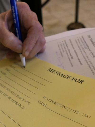 ALCU of Georgia supporter filling out a message to a lawmaker on Crossover Day at the Georgia State Capitol.