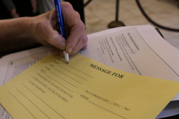 ALCU of Georgia supporter filling out a message to a lawmaker on Crossover Day at the Georgia State Capitol.