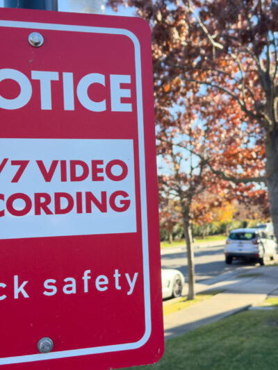 Photo of a notice sign alerting a neighborhood to the use of Flock cameras.