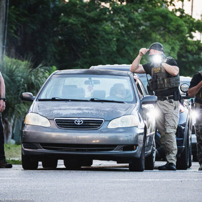 Federal law enforcement searching a vehicle.