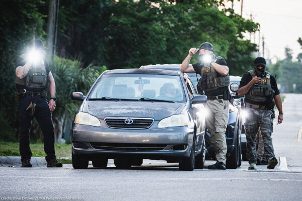 Federal law enforcement searching a vehicle.