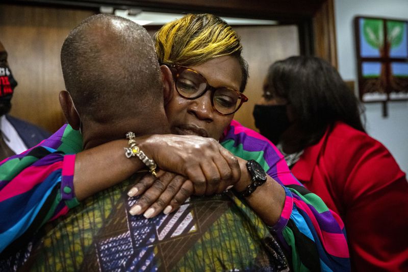 Ahmaud Arbery's mother, Wanda Cooper-Jones his hugged by a supporter after the jury convicted Travis McMichael in the trial of McMichael, his father, Greg McMichael, and neighbor, William "Roddie" Bryan, Wednesday, Nov. 24, 2021, in the Glynn County Courthouse in Brunswick, Ga. The three defendants were found guilty Wednesday in the death of Ahmaud Arbery. (AP Photo/Stephen B. Morton, Pool)