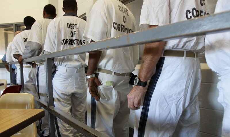 Inmates at Phillips State Prison wait in line for lunch in the cafeteria Thursday, October 27, 2011.