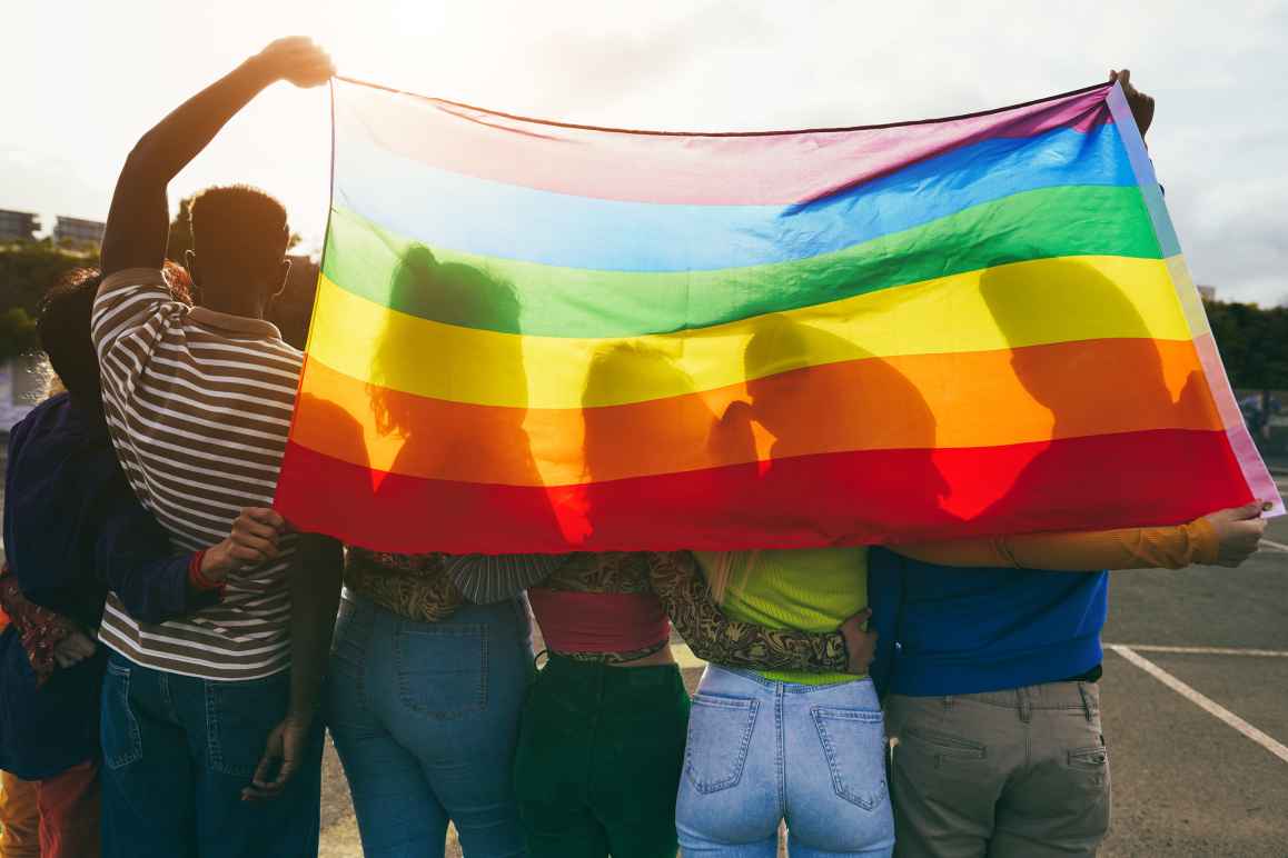 youth with rainbow flag
