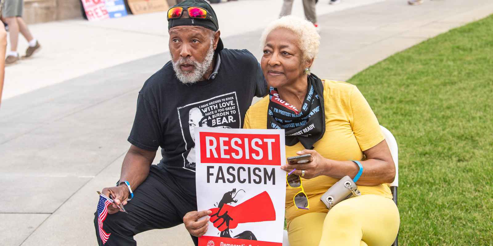 Couple holding sign that says resist fascism