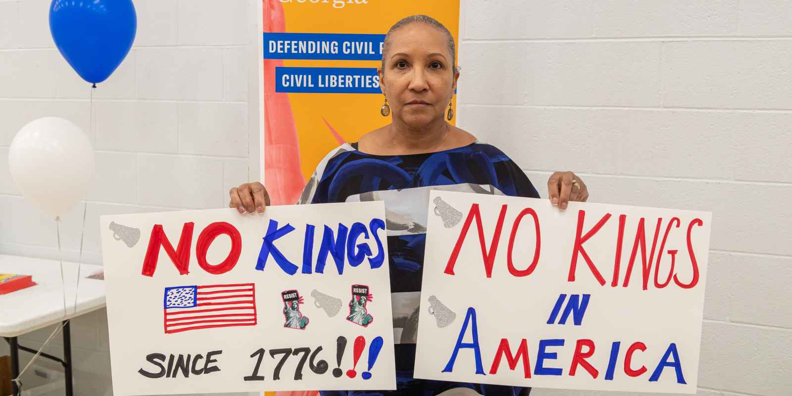 Protest Ready GA sign making party volunteer holding signs