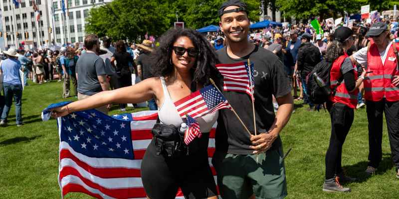 No Kings rally attendees holding American flags