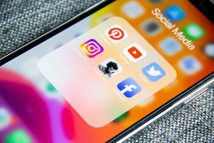The screen of a mobile phone with social media icons on it