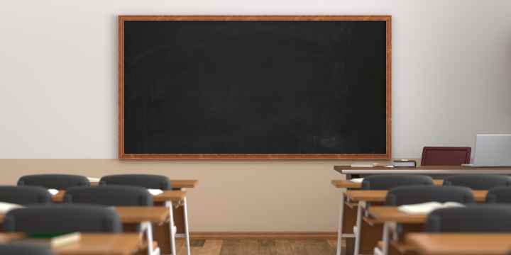 classroom with desks facing chalkboard