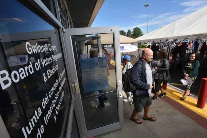 People lined up early voting outside the Gwinnett County Voter Registrations and Elections Office in Lawrenceville on Thursday, October 18, 2018. HYOSUB SHIN / HSHIN@AJC.COM Federal judge mulling action over Georgia absentee ballots.