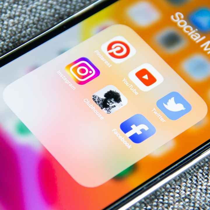 The screen of a mobile phone with social media icons on it