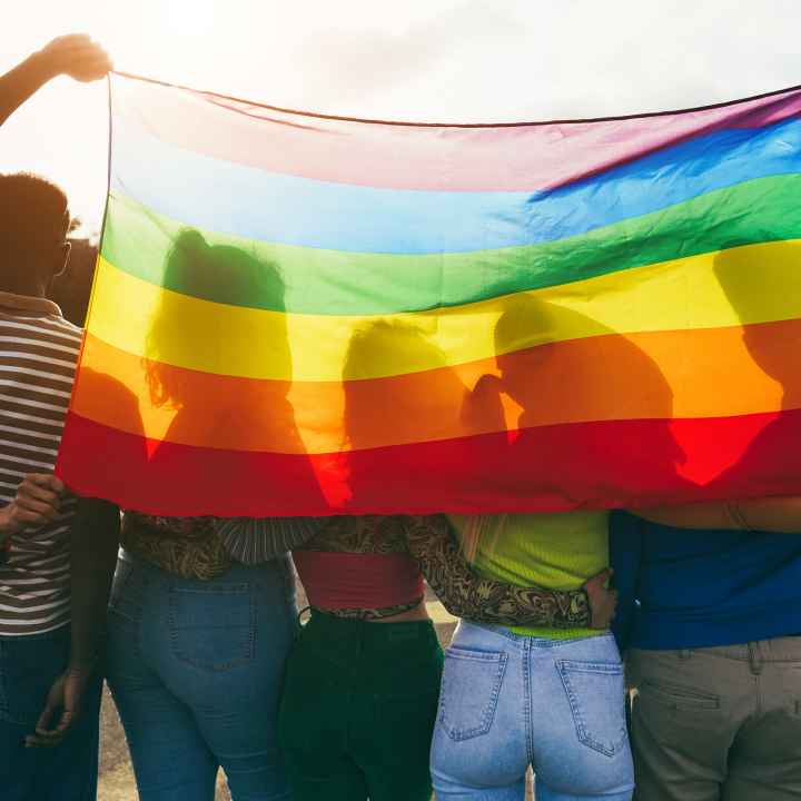 youth with rainbow flag