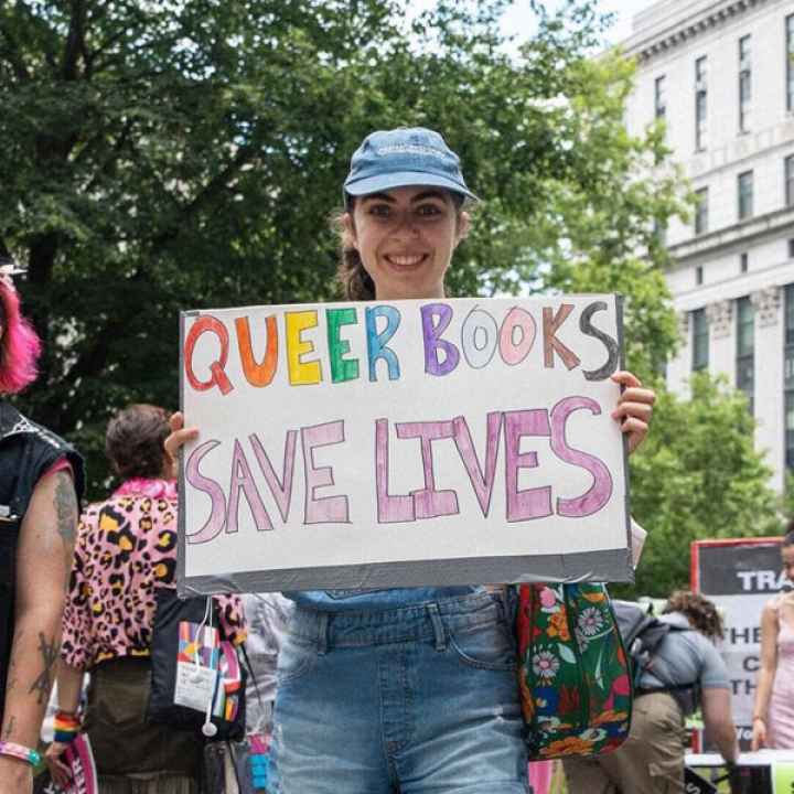 Protestor holding LGBTQ+ positive sign